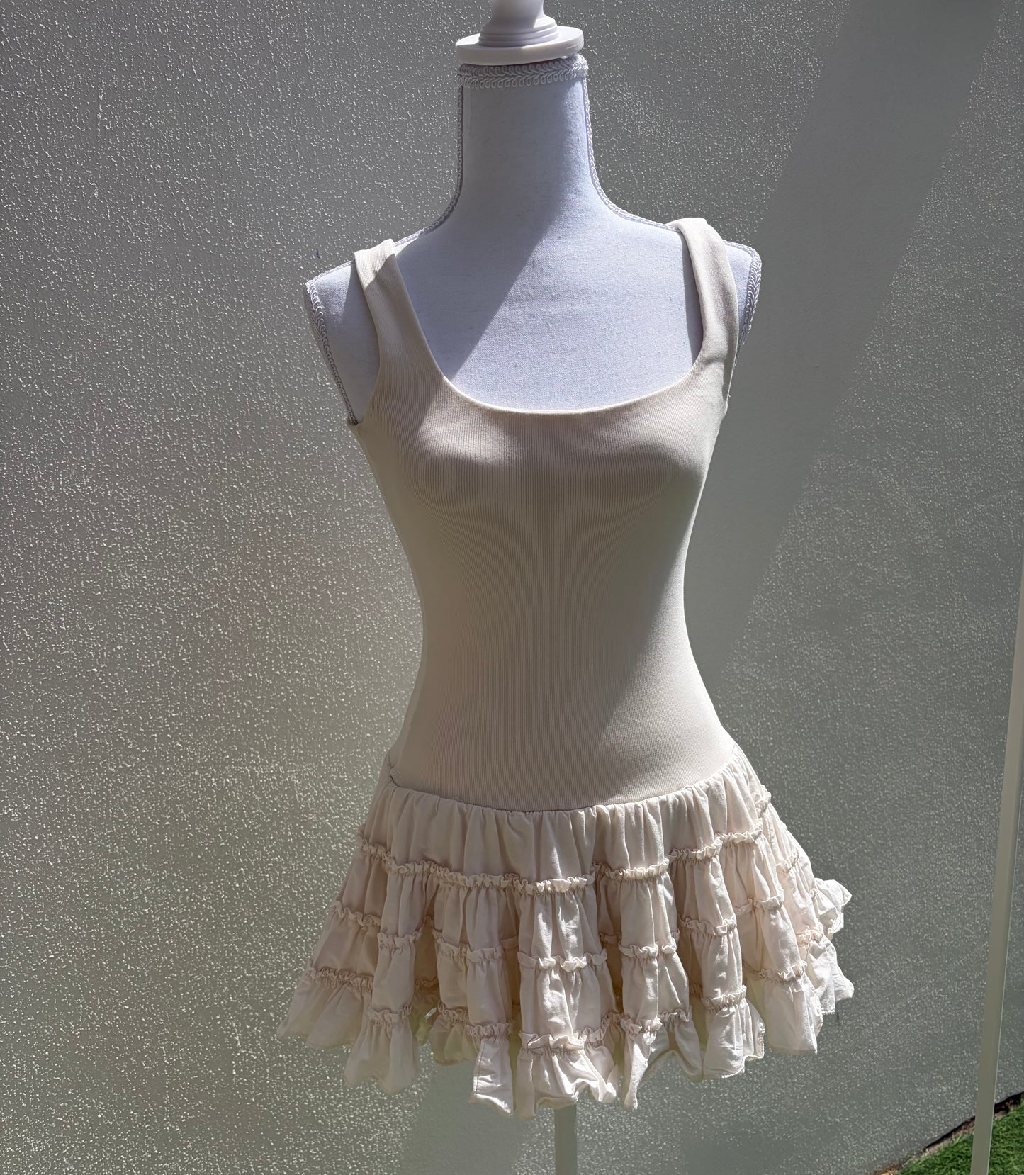 A flattering cream ribbed mini dress