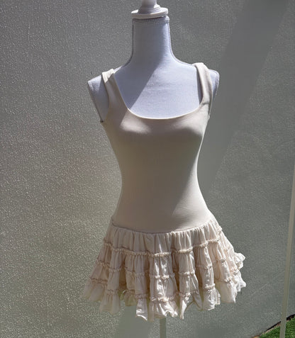 A flattering cream ribbed mini dress
