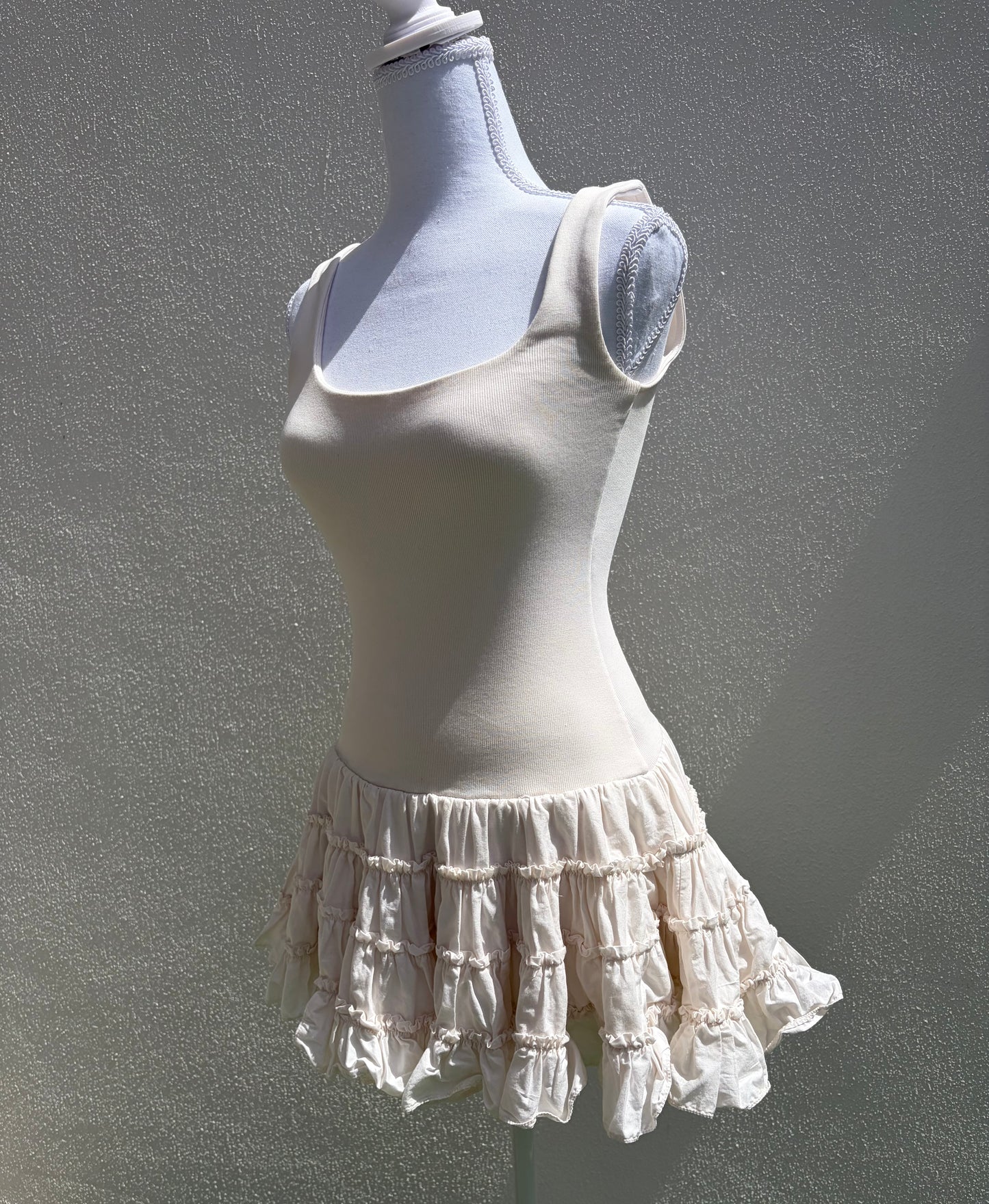 A flattering cream ribbed mini dress