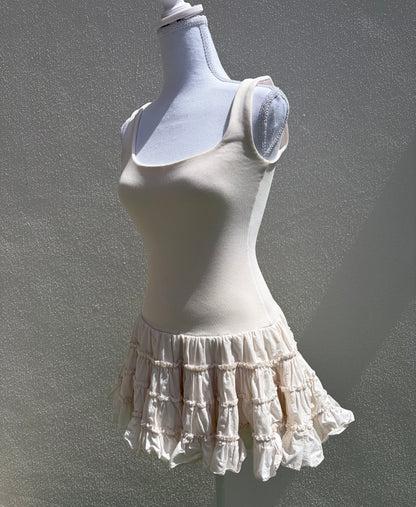 A flattering cream ribbed mini dress