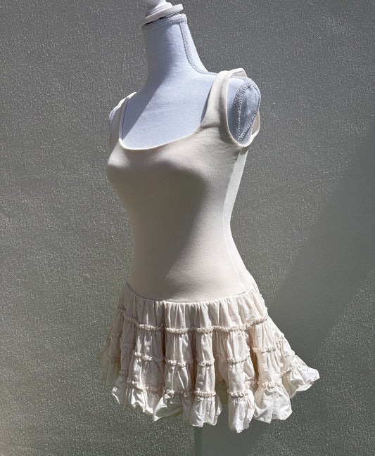 A flattering cream ribbed mini dress