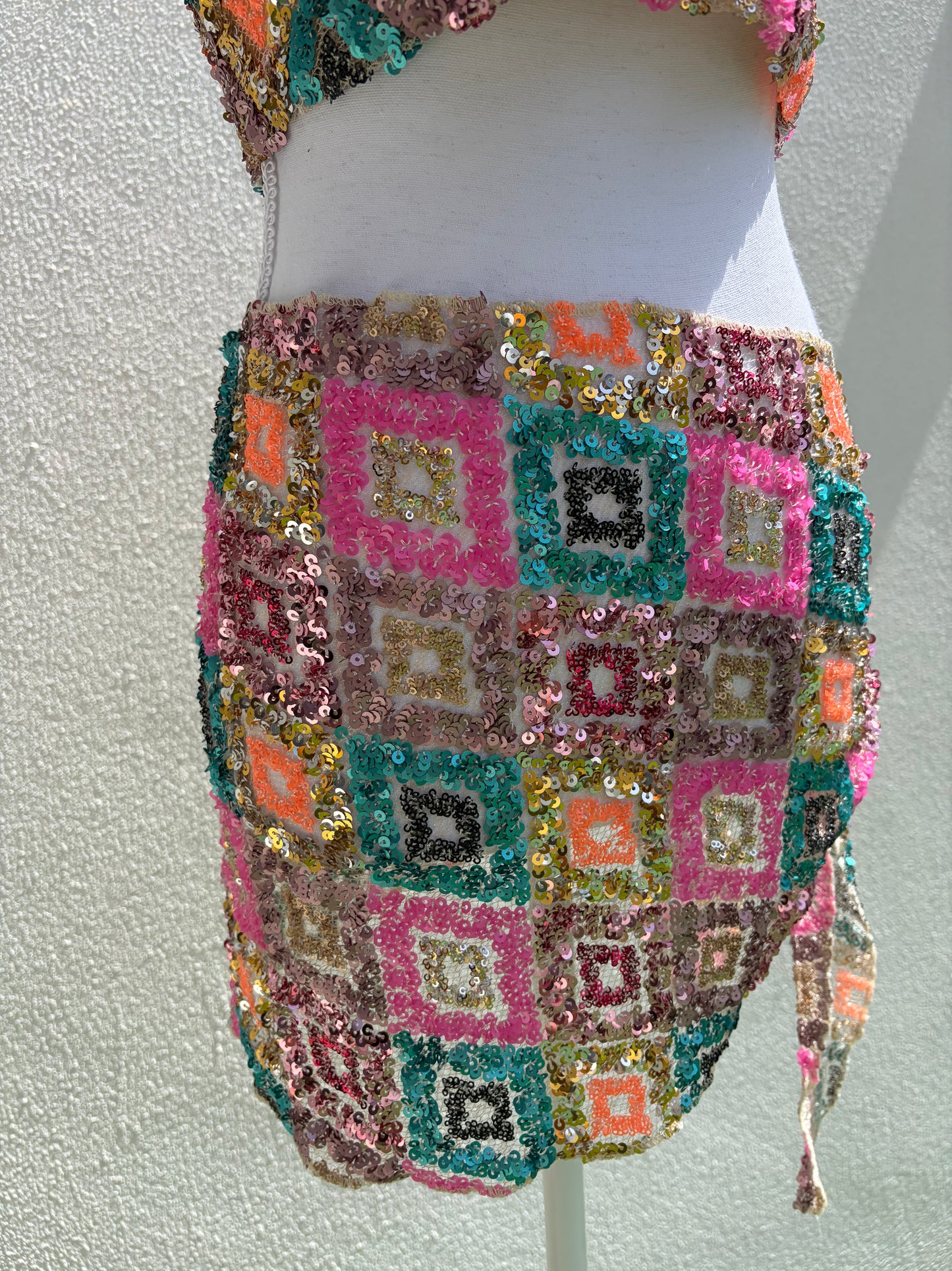A vibrant three-piece sequin beach set
